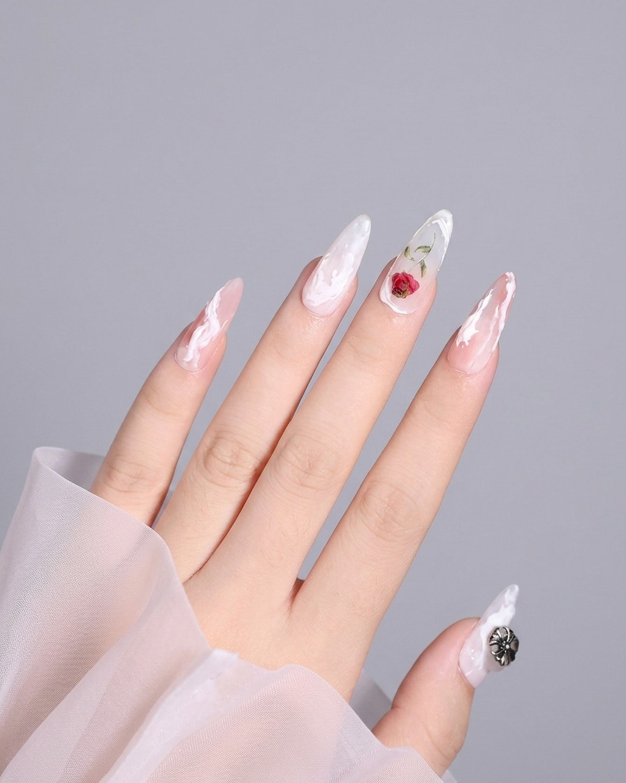 A detailed shot of a thumb nail with a completed 3D design including a white swirl near the edge.