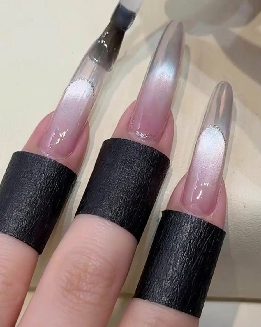 A gel brush applying a clear top coat over the nail design in preparation for curing under a UV lamp.