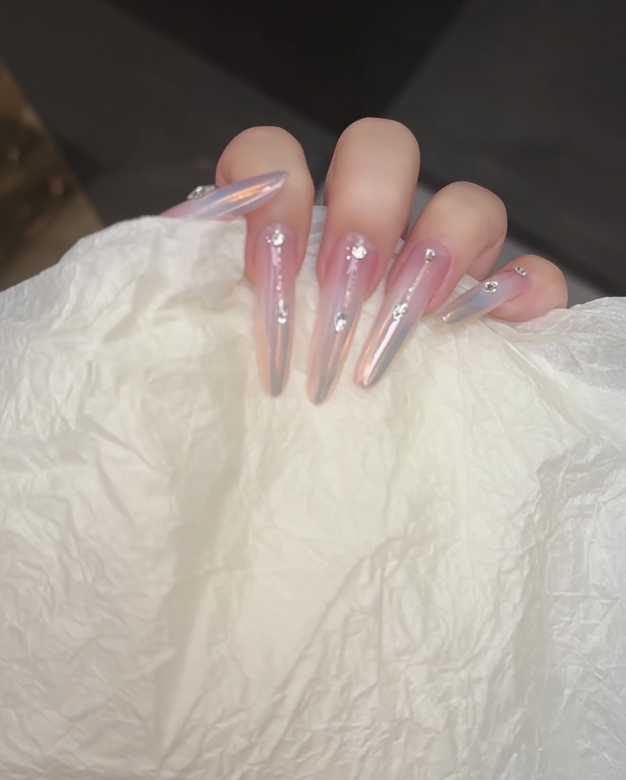 A nail brush adding a second layer of blushing gel to deepen the gradient.