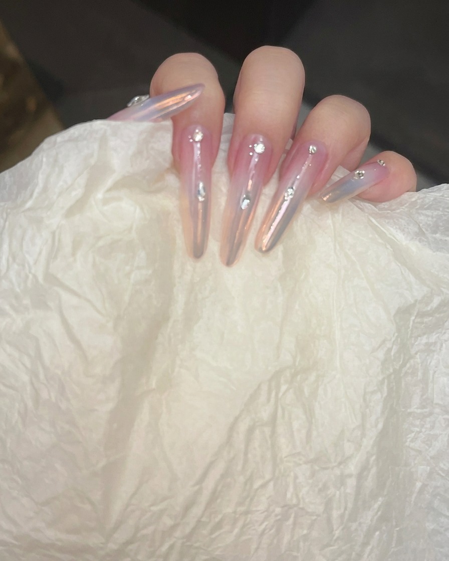 Nails being placed under a professional UV/LED lamp to cure the strengthening top coat.