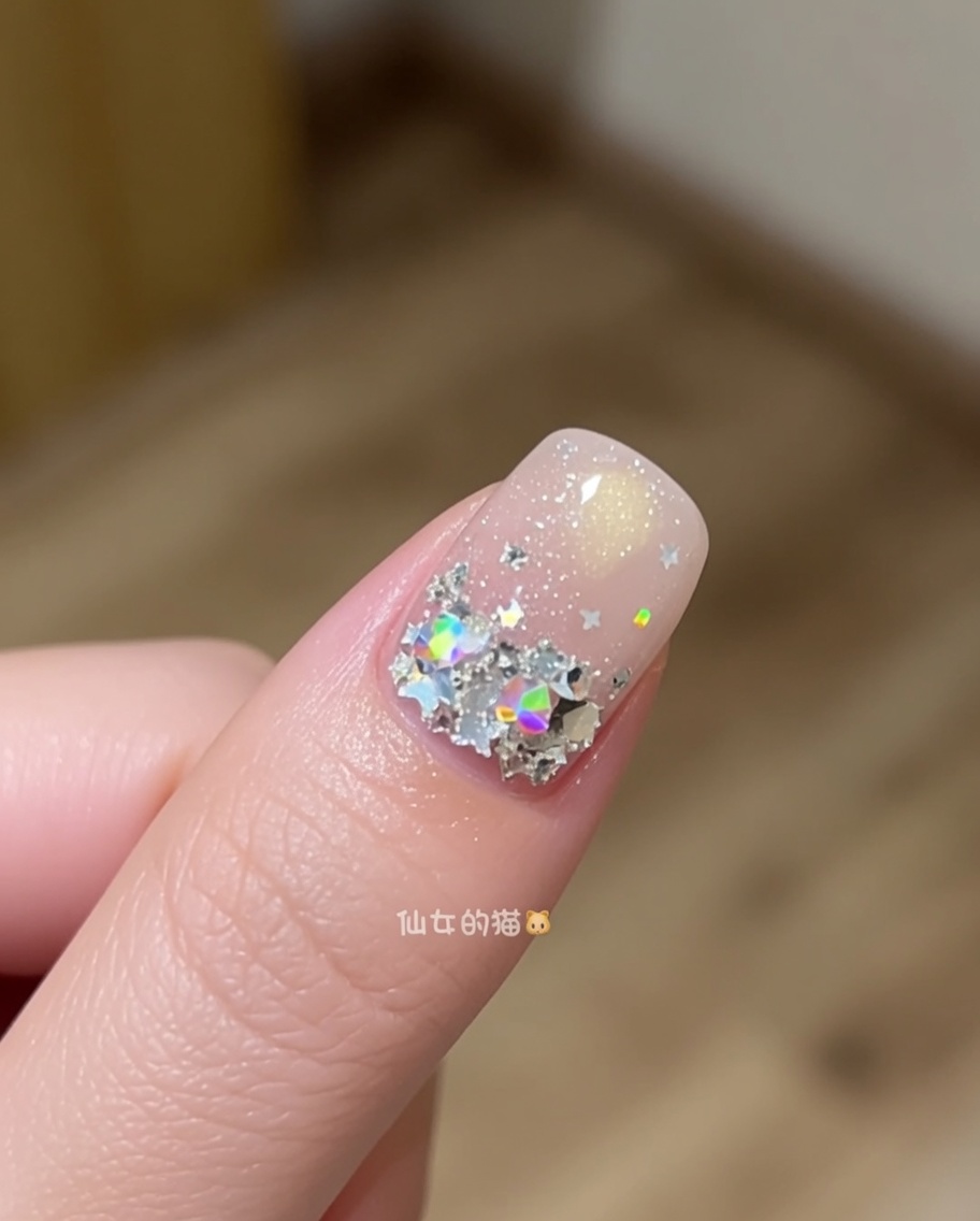 A short nail brush being used to manipulate and smooth out builder gel on a nail surface.