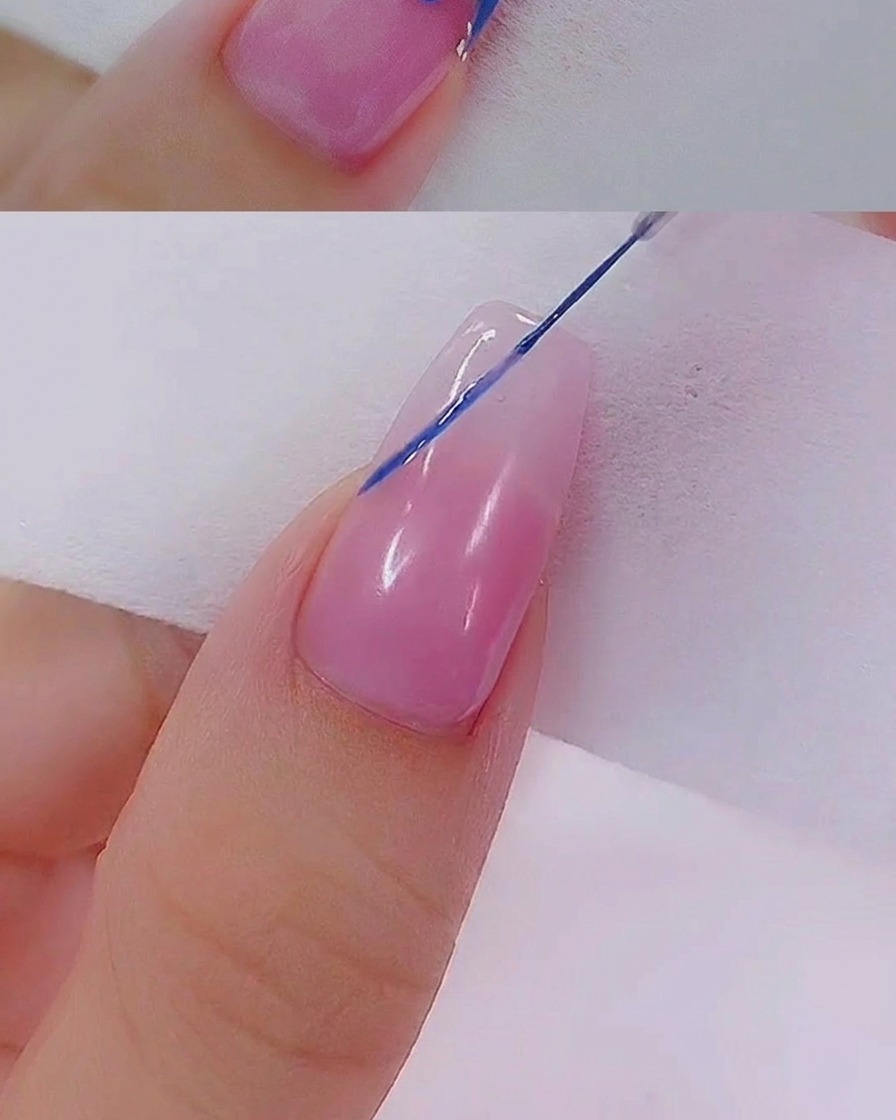 Two small blue dots sitting side-by-side on the surface of the nail, created with a dotting tool.