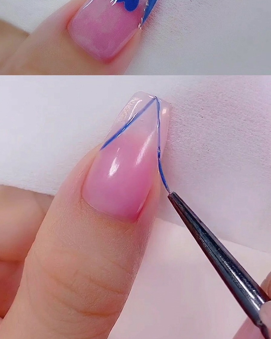 A fine brush applying a thin line of rose gold glitter gel along the edge of a French tip design.