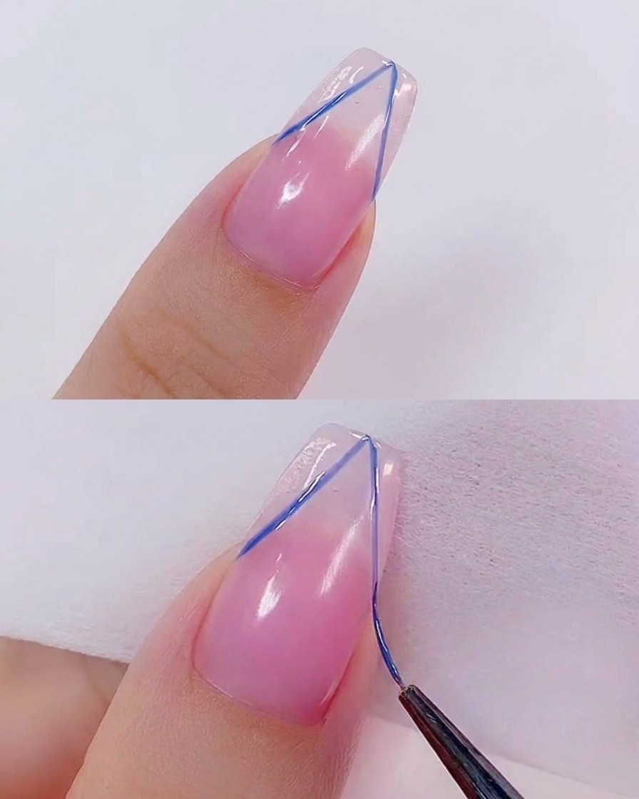 A brush applying a clear, glossy top coat over the completed nail art design.