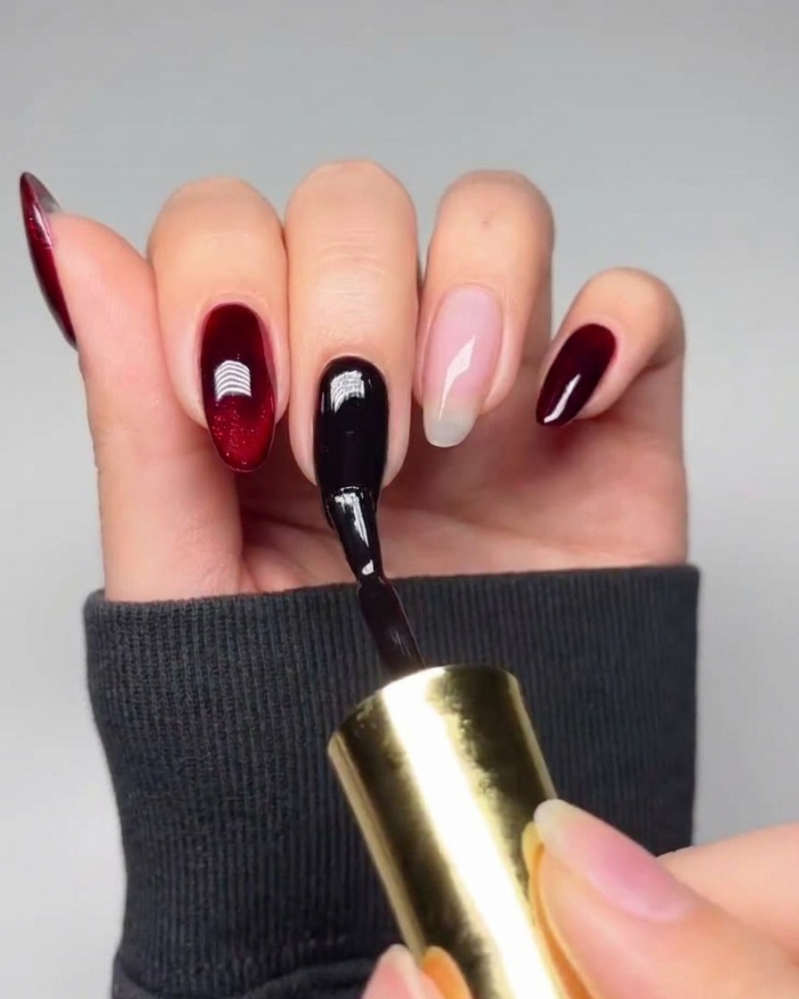A pair of tweezers positioning a small heart-shaped stencil in the middle of a black gel-painted nail.