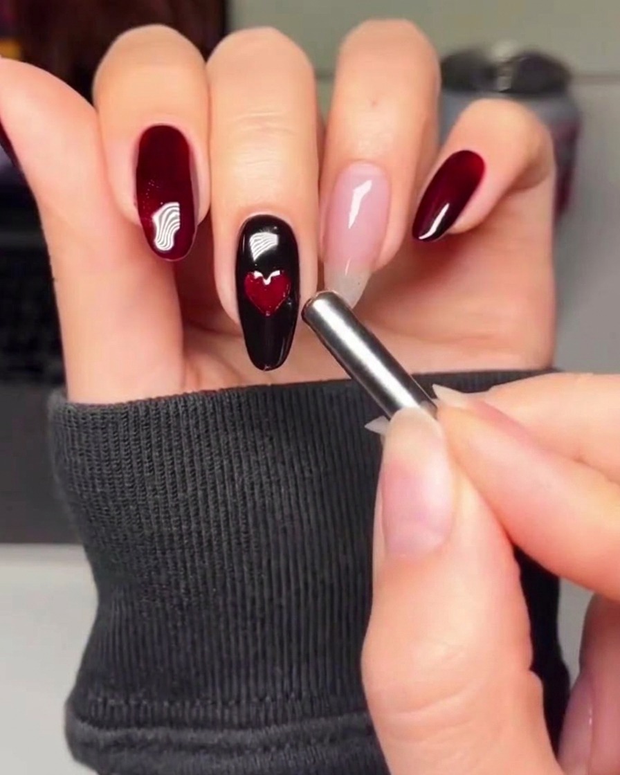 A soft nail buffer smoothing the surface of a manicured nail.