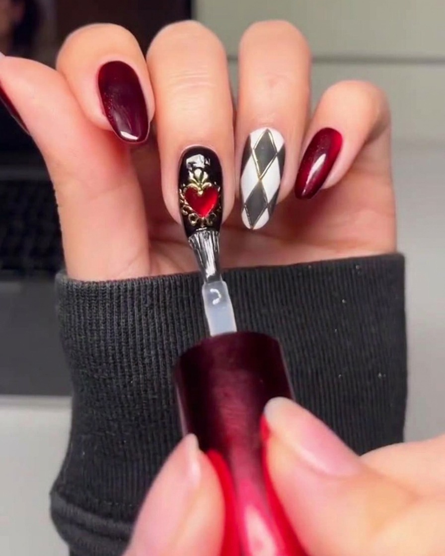 A brush applying a final layer of clear glossy top coat over the finished nail art designs.
