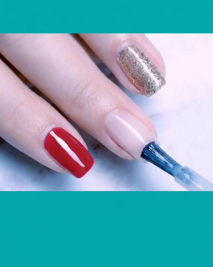 A brush applying a second layer of milky white base polish to the nail surface.