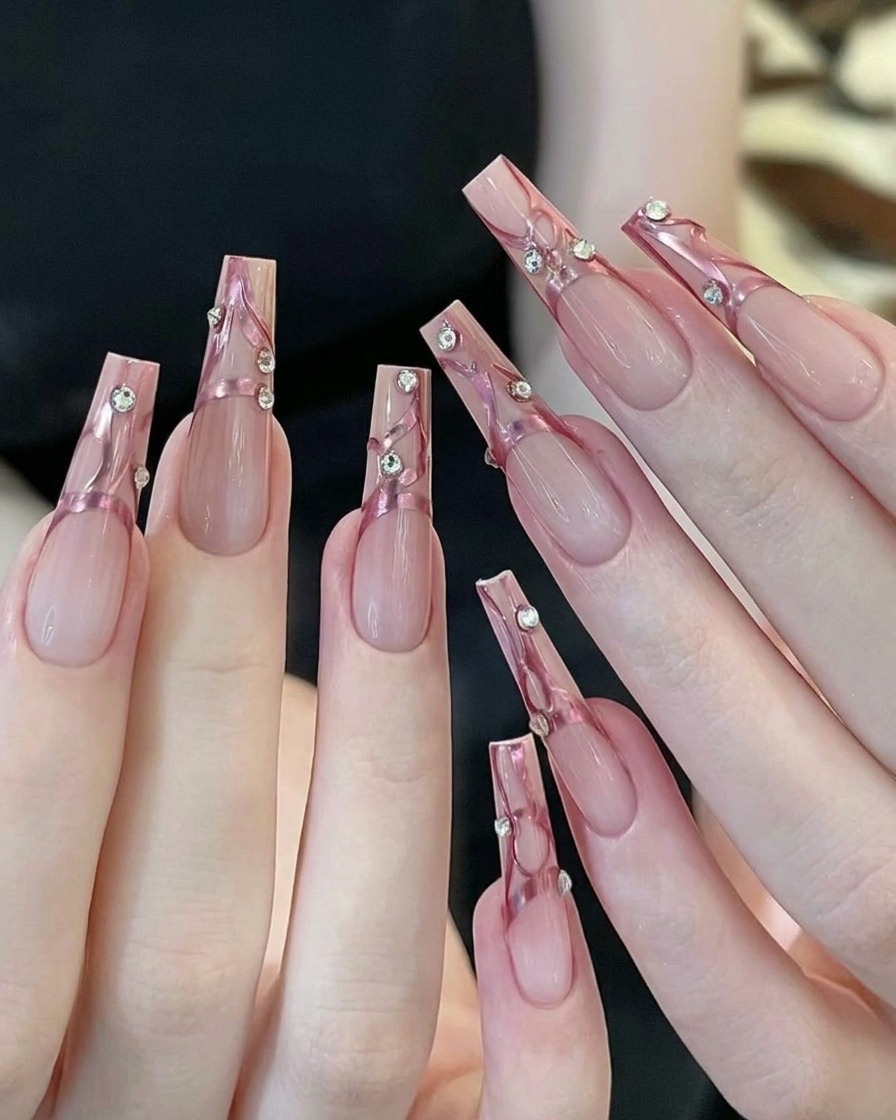 A yellow makeup sponge wedge with pink gel polish being patted onto the tip of a clear nail.