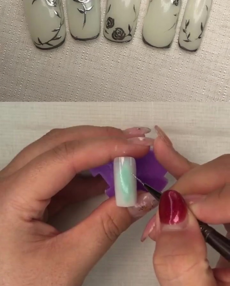 A brush applying a coat of sheer milky white gel polish to a nail.
