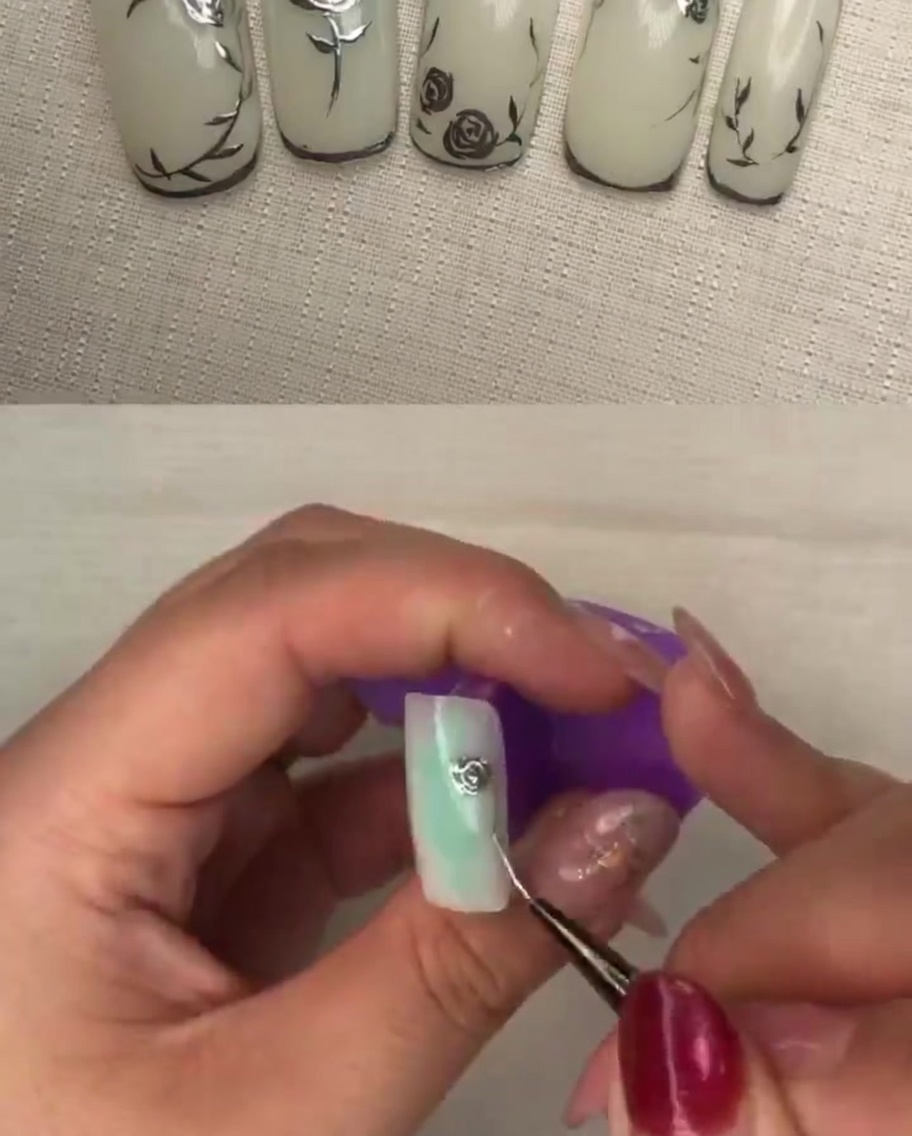 A close-up of a brush applying pressure to metallic gel petals to create texture and depth.