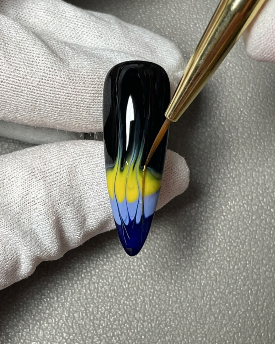 A hand positioned under a professional UV/LED nail lamp, showing the black base coat being cured.