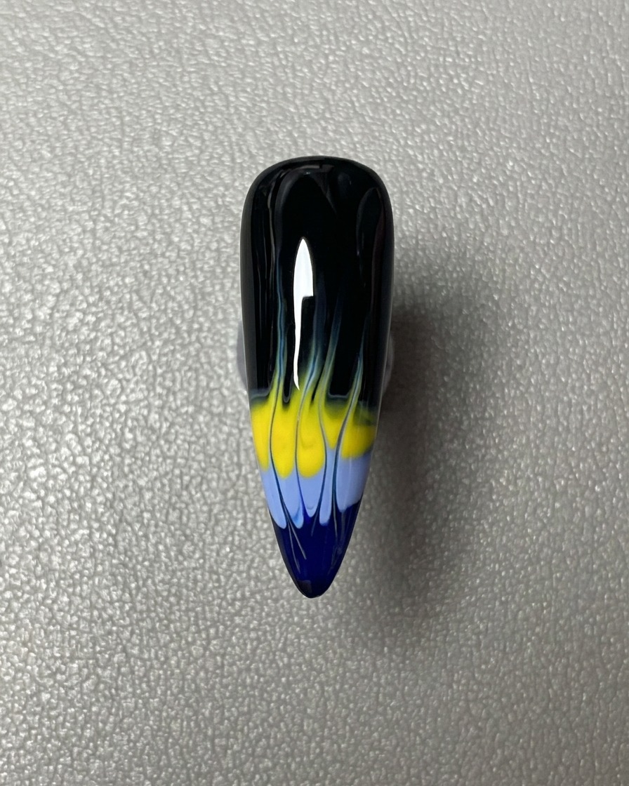 A horizontal stripe of blue gel polish applied across the tip of the black-coated nail.