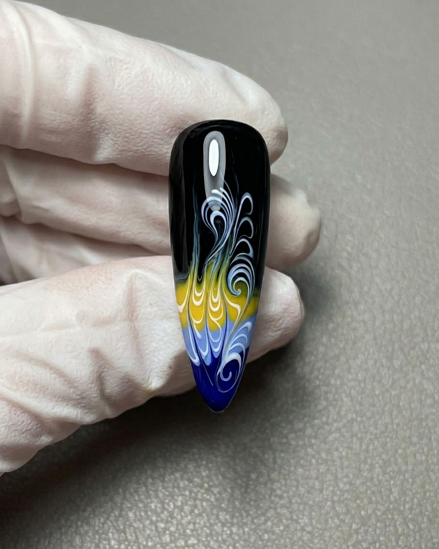 A close-up view of the completed flame nail art design on a black base with intricate white detailing.