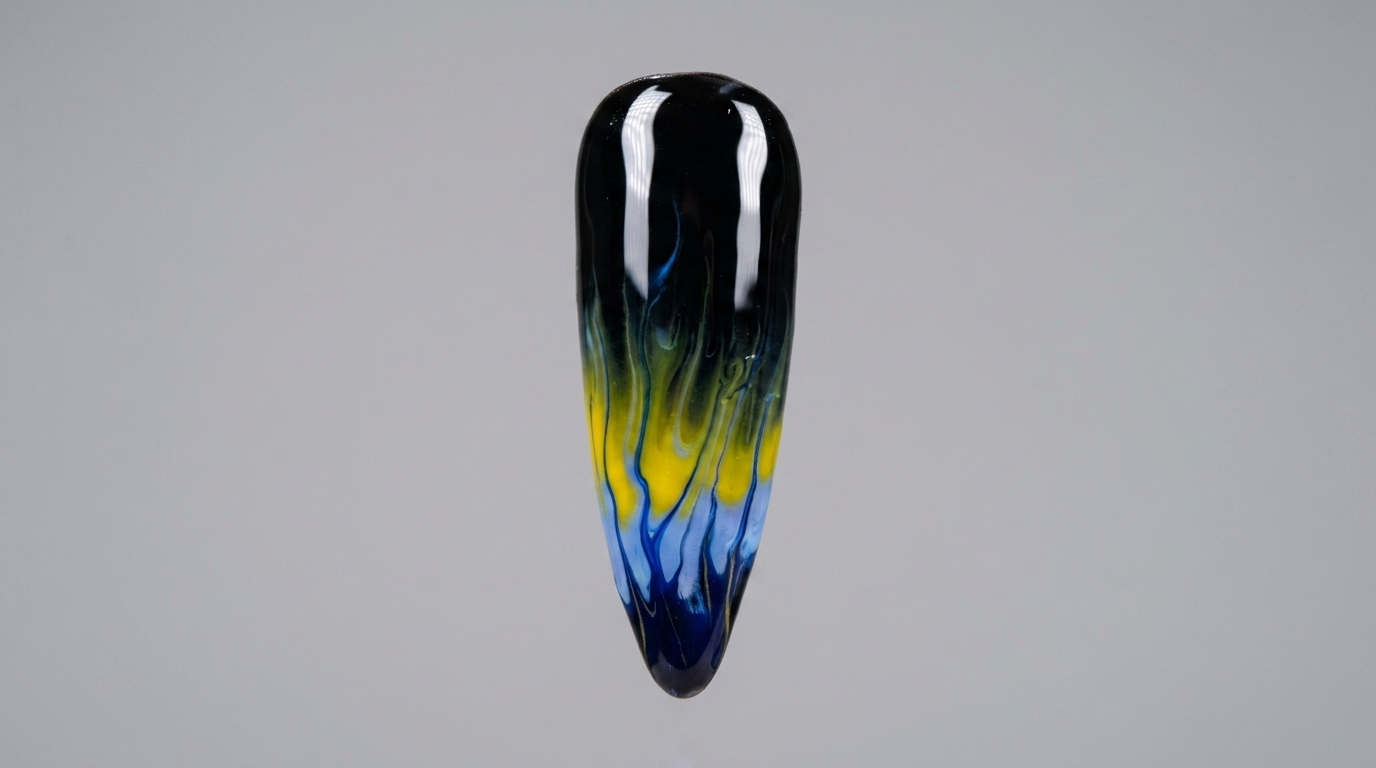 A close-up of a finished almond-shaped nail featuring vibrant blue and yellow flame art over a glossy black base.