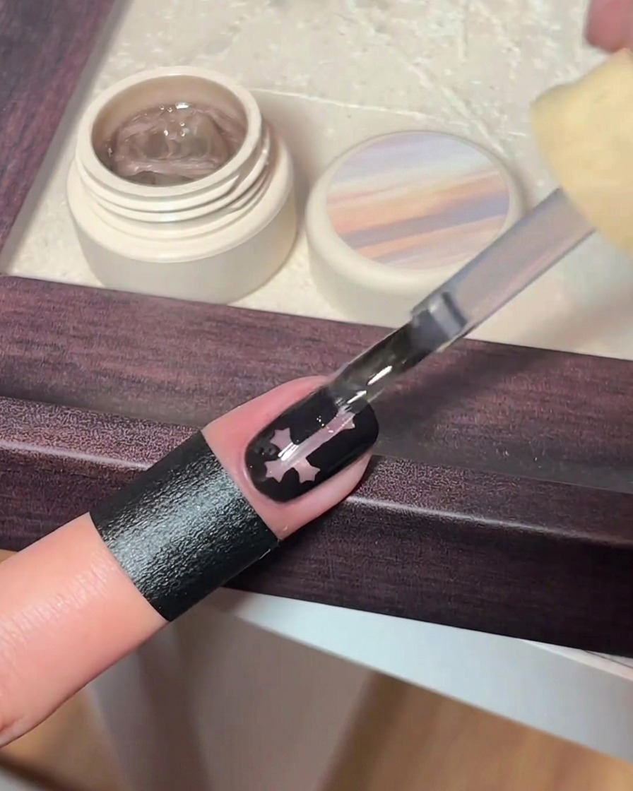 A finger placed under a professional UV nail lamp for curing.