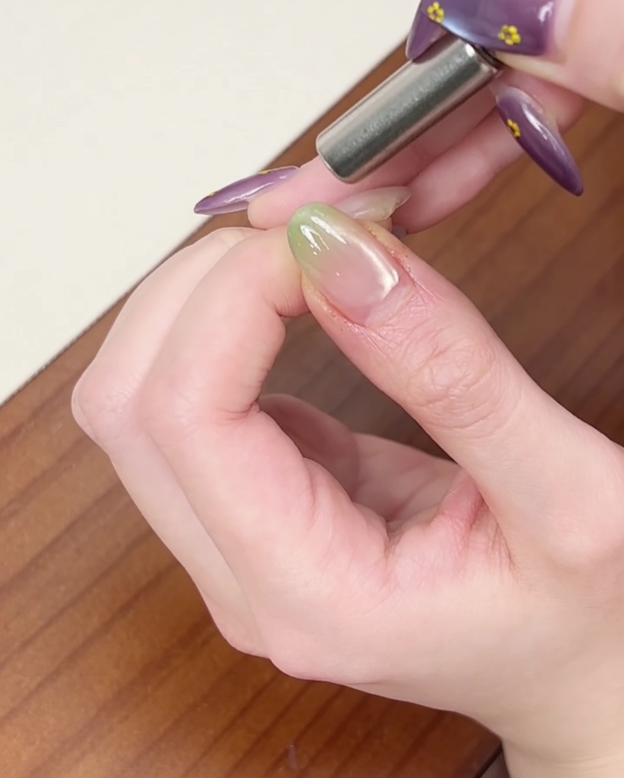 A cylindrical magnet held near the side of the nail to create a cat-eye shimmer effect.