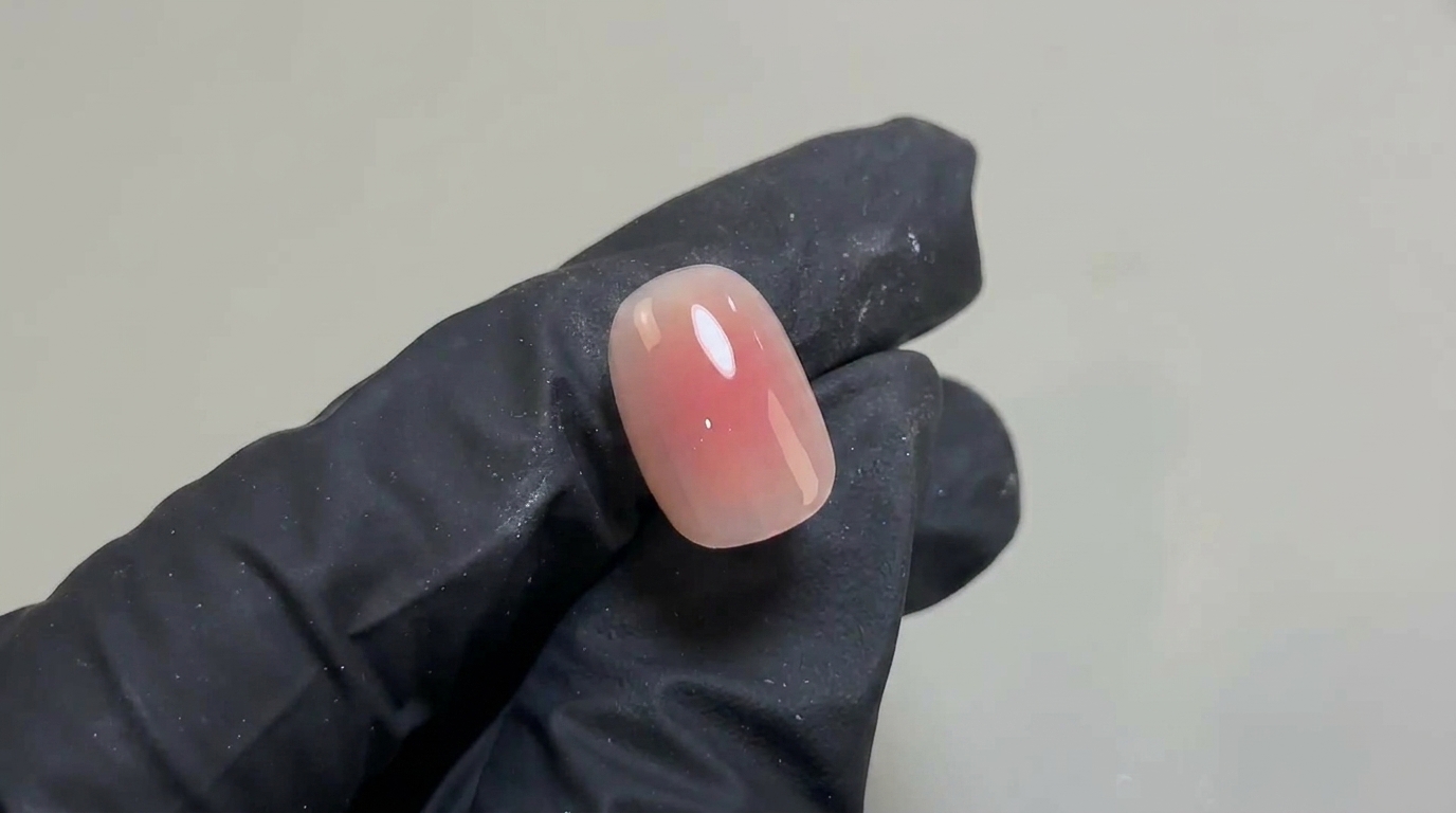 A delicate, natural blush gel nail design featuring a soft pink gradient on a short, rounded nail with a high-gloss finish.