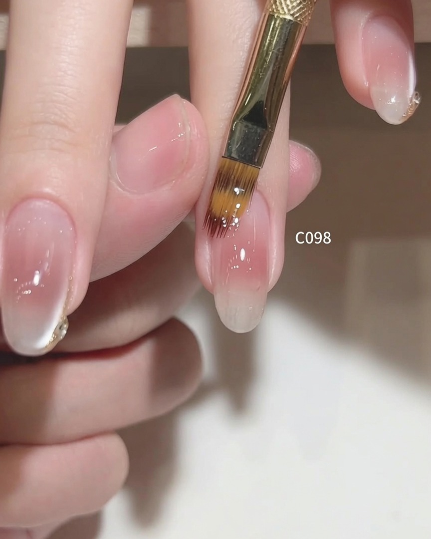 Gently brushing the surface of the nail to finalize the gel coat application.