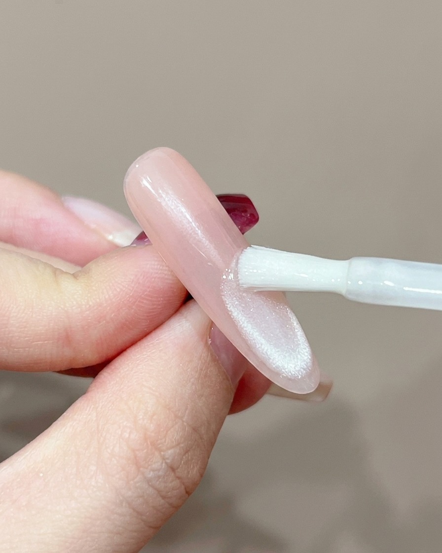 A nail positioned under a professional UV lamp for curing.