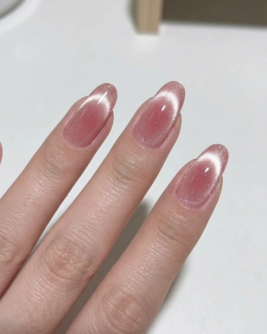 A magnetic tool held near a fingernail to manipulate the shimmer pigments in the polish.