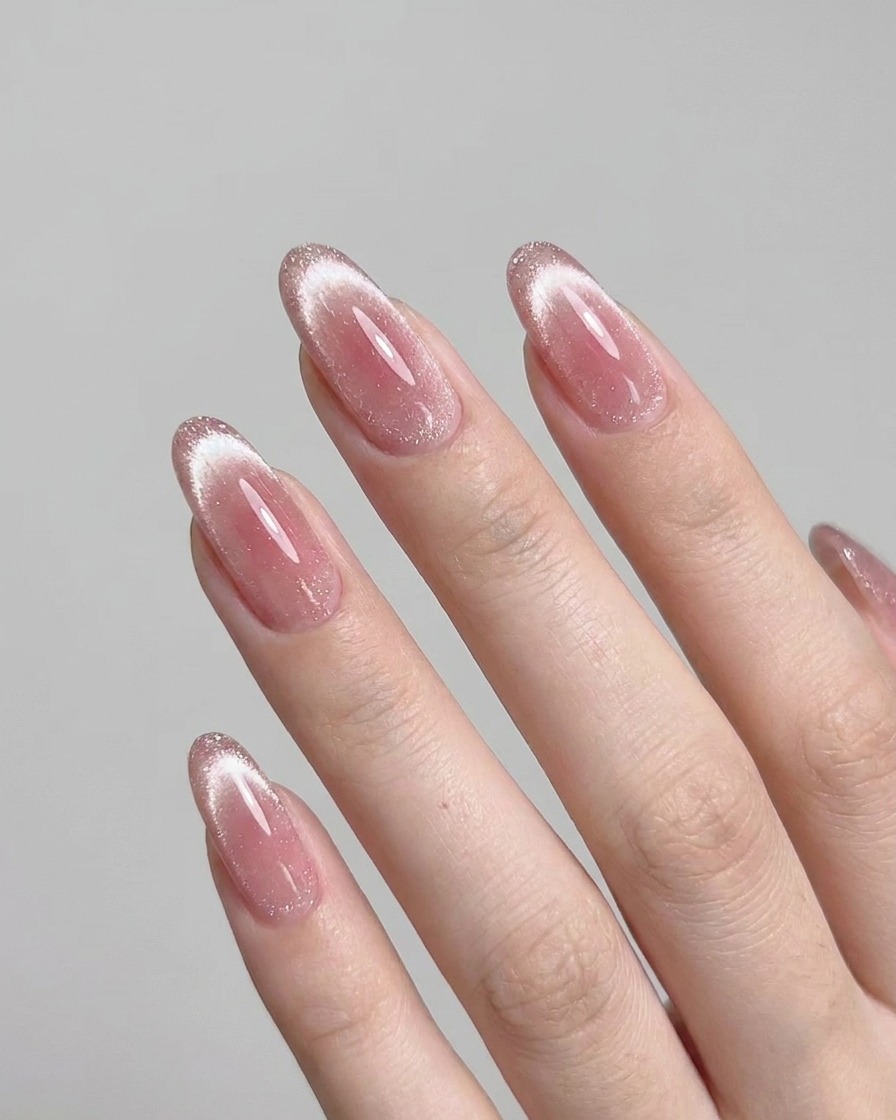 A hand resting inside a UV nail lamp, with nails clearly visible as they cure.