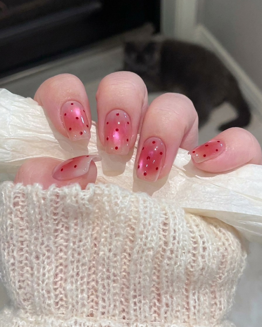 A close-up view of nails curing inside a UV lamp after the concealing gel application.