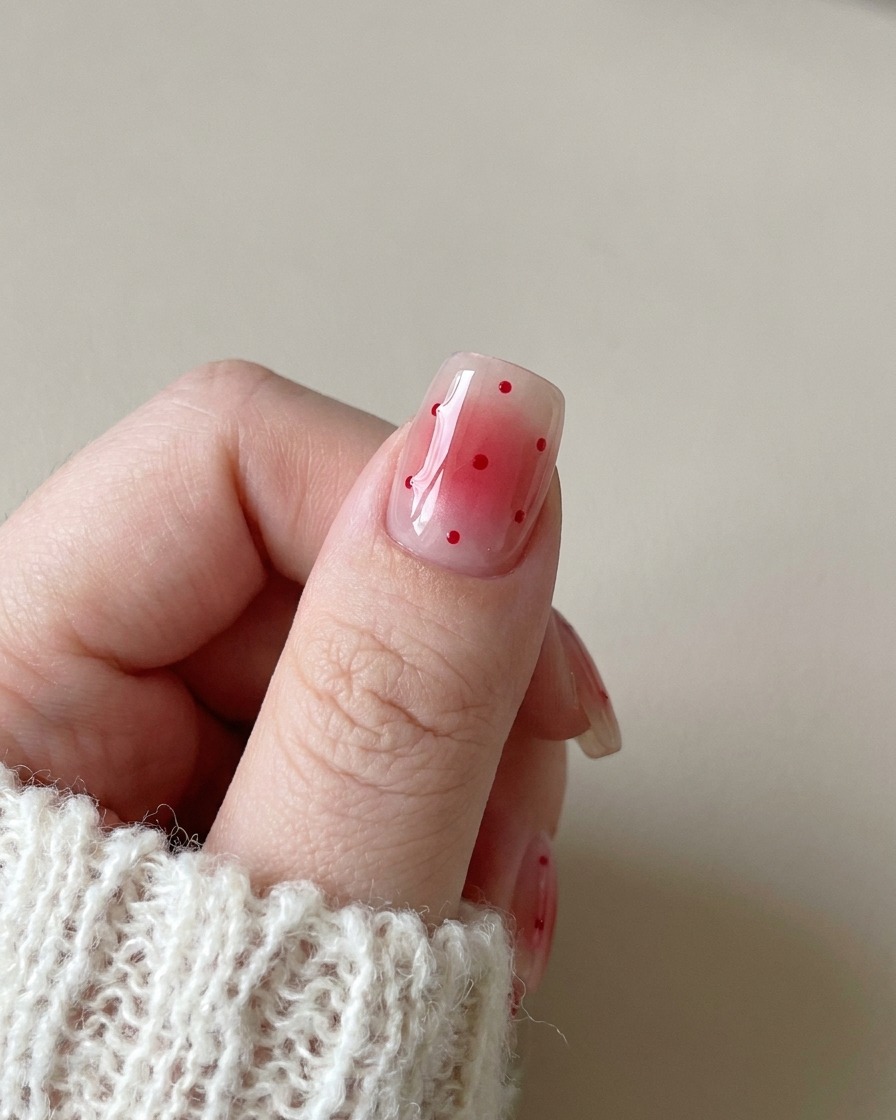 A close-up view of a magnetic tool hovering over a gel-coated nail to create a diagonal cat-eye shimmer effect.