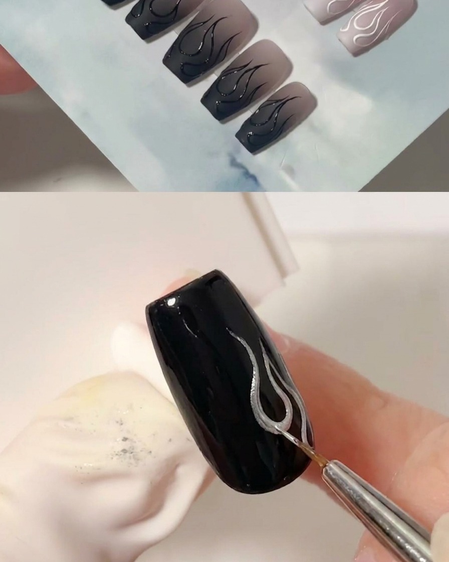 A fine liner brush adding a second curved black line to form the right side of the flame design.