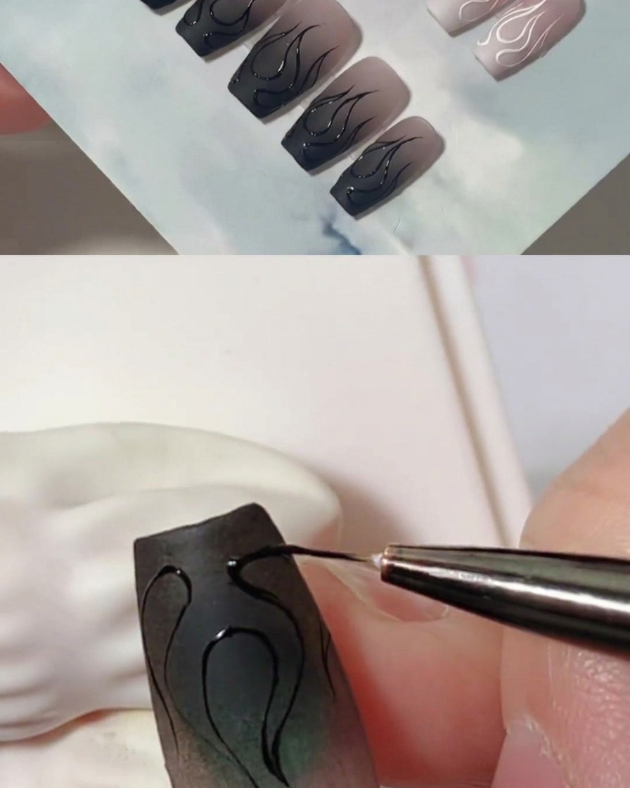 A close-up shot showing a liner brush adding layers of black gel to thicken the flame outlines on a matte nail.