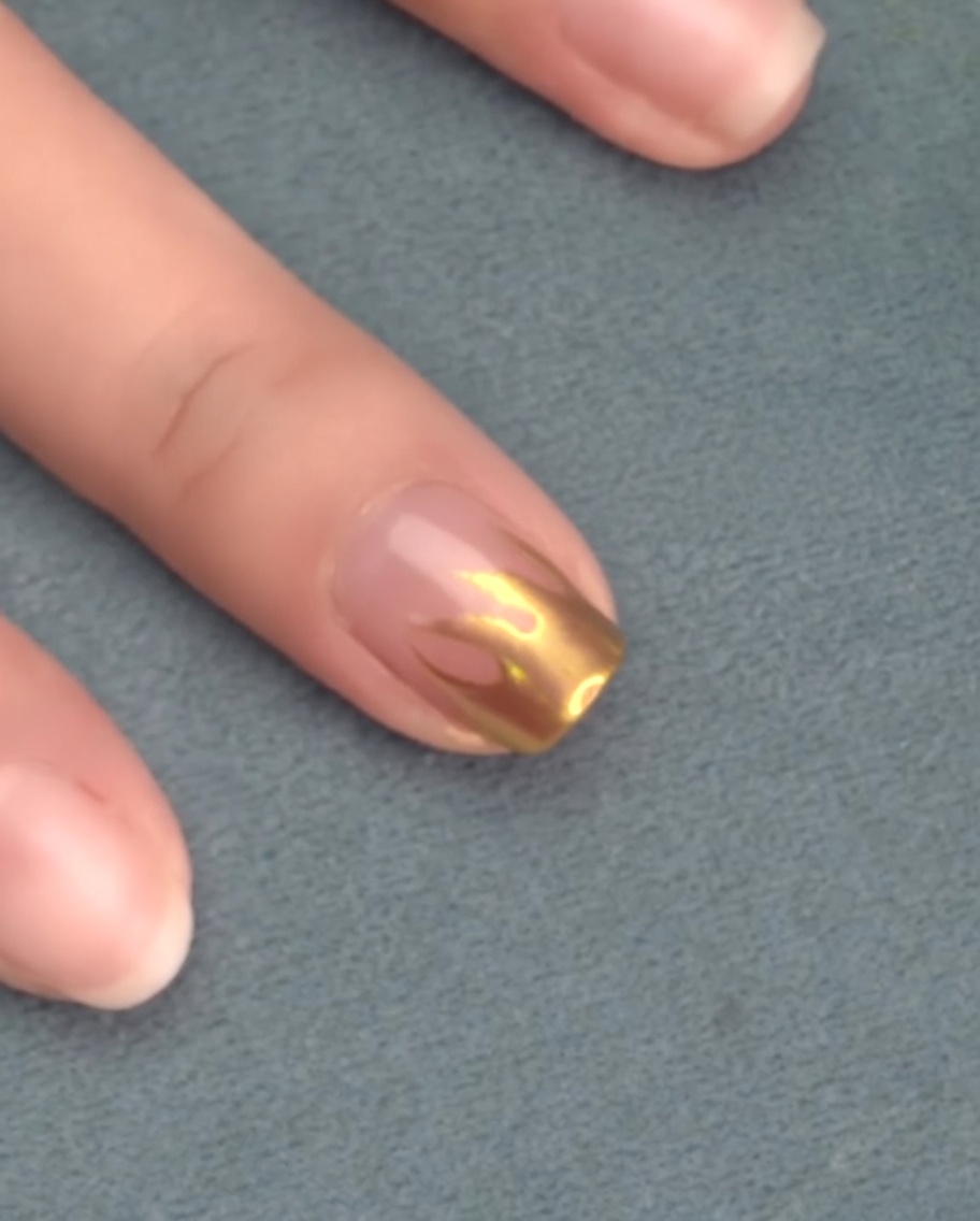 Nails inside the curing lamp during the matte top coat cycle.