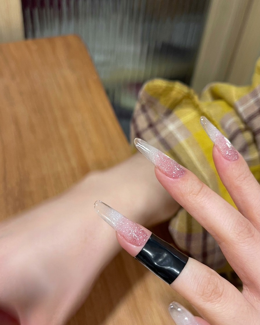 A fingernail curing under the light of a UV/LED nail lamp.