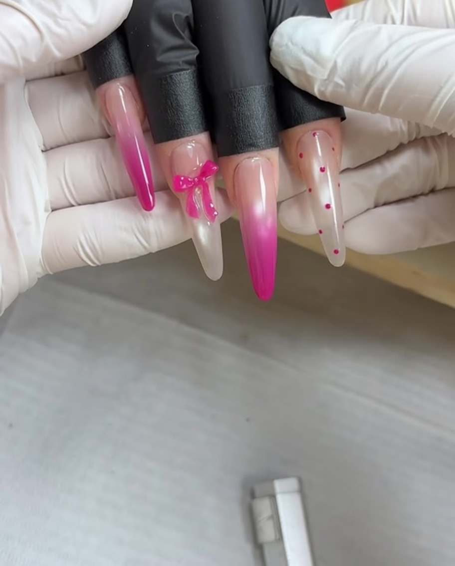 A hand resting inside a UV nail lamp to cure the gel polish.