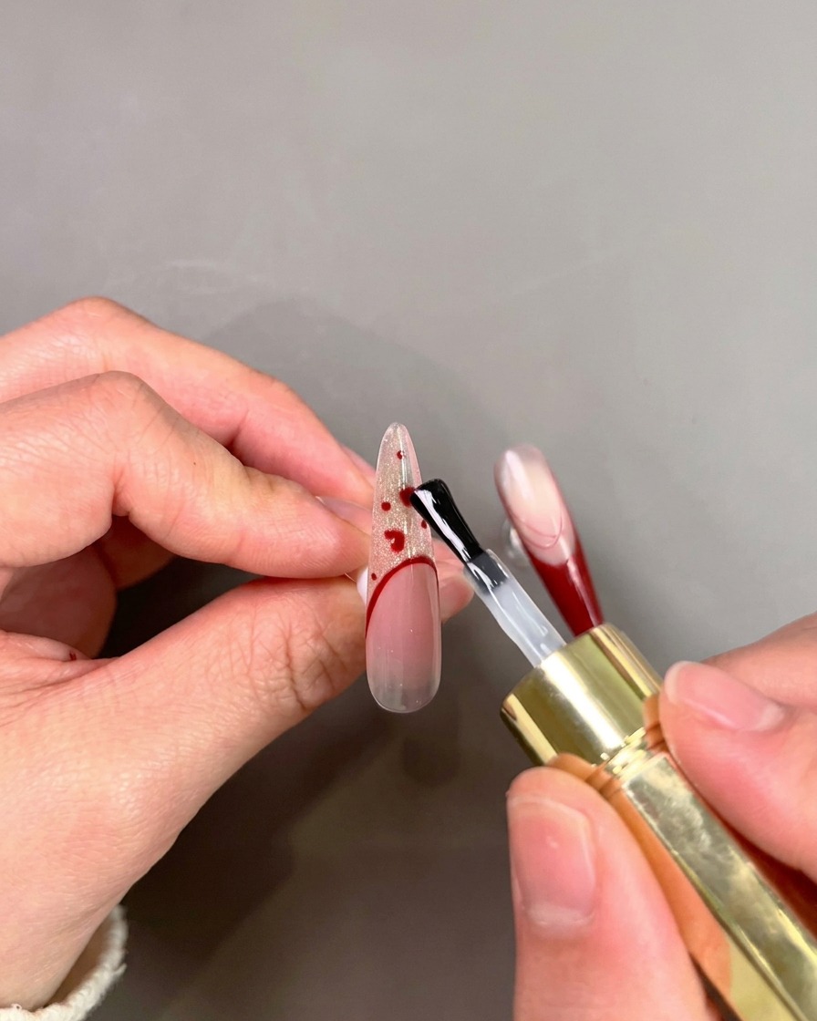 A view of a nail tip inside a UV/LED lamp being cured.