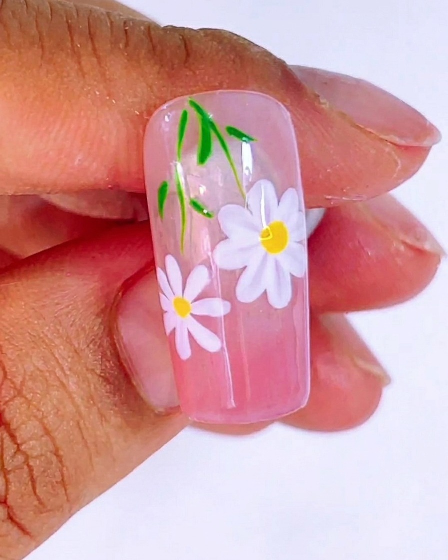 The finished nail design under the UV light during the final 120-second curing process.