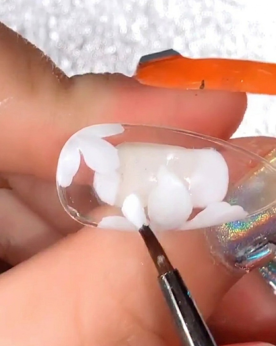 Detail brush adding more white gel petals over the initial cured design to increase the volume of the daisy.