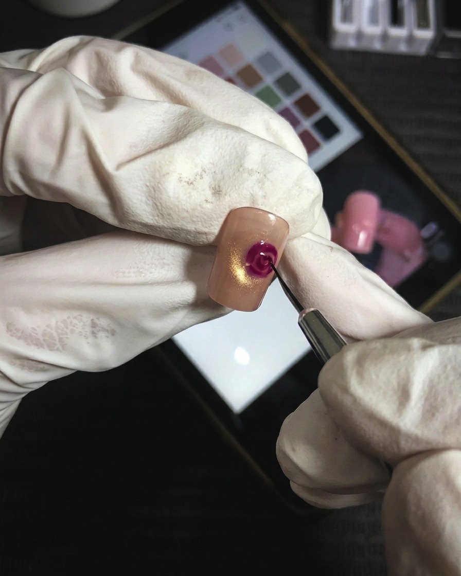A fine-tip brush adding precise magenta gel lines to increase the definition of rose petal layers.