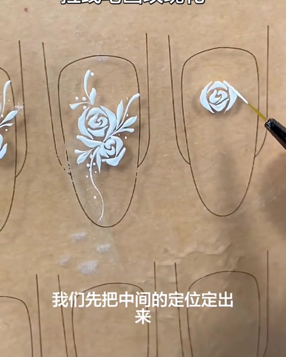 A liner brush adding small, curved strokes to the sides of the rose to build up its volume.