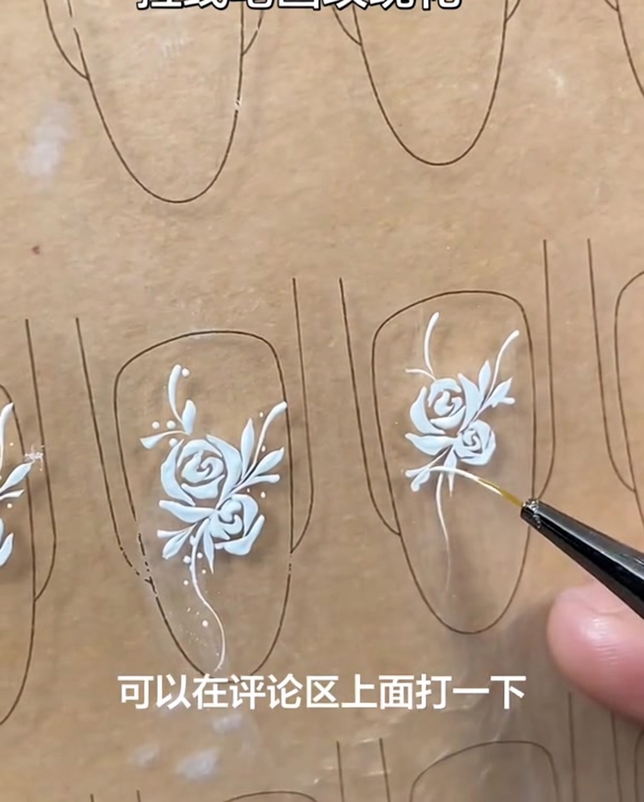 Finished nail art design with a white rose, vine, leaves, and small dot accents, clearly visible on the nail tip.