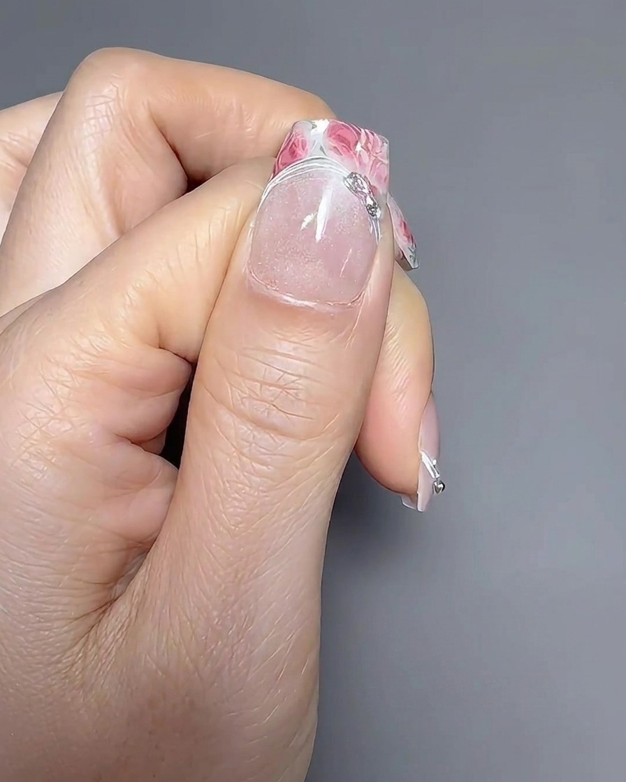 Close-up of a liner brush applying a thin gel line along the smile line of a French manicure.