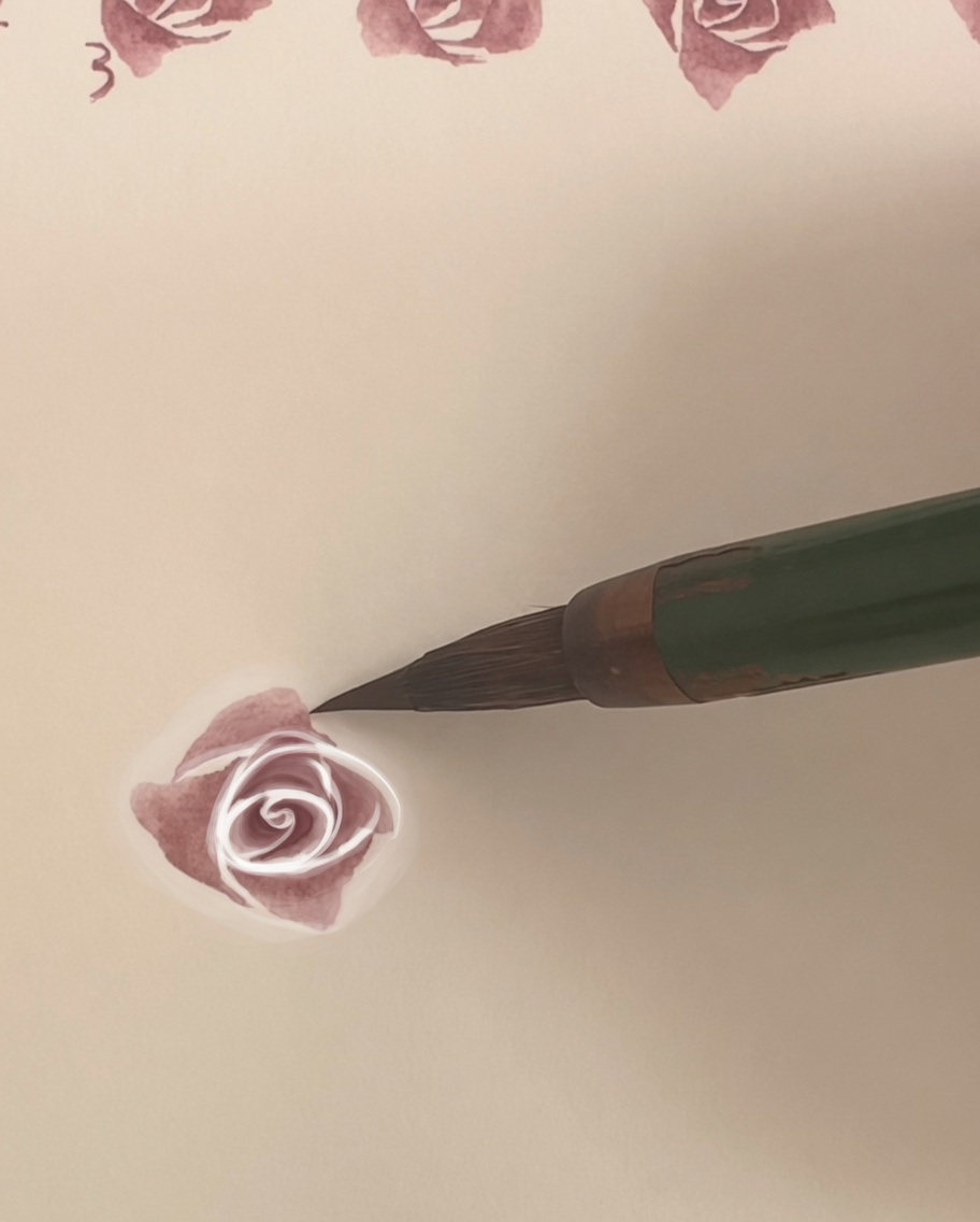 A watercolor rose on paper with a fourth, larger outer layer of petals being applied.