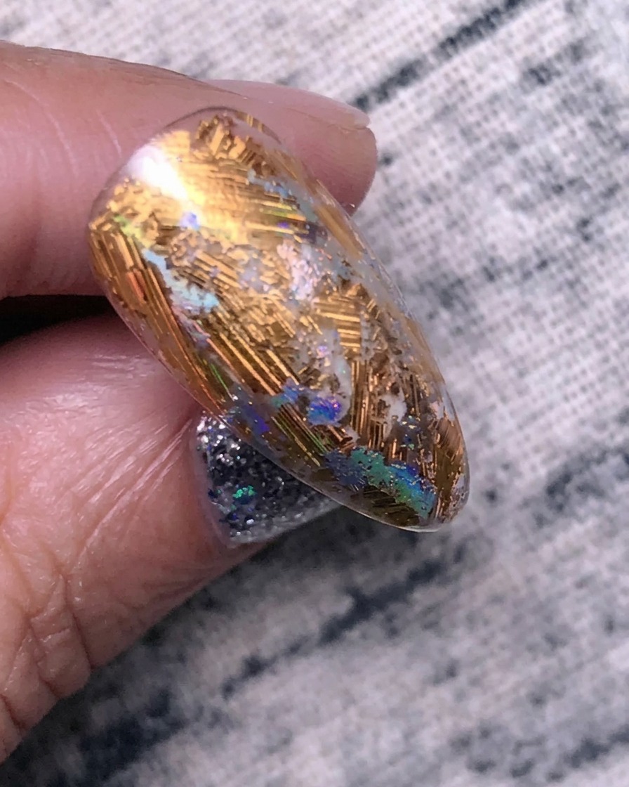 Nails curing under a UV/LED lamp after the strengthening gel application.