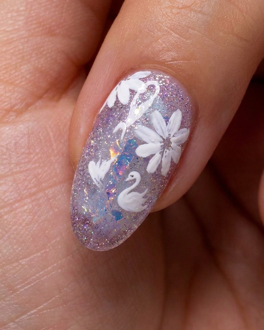 Close-up of a nail with partially painted white daisy petals on a sparkly background, being refined with a detail brush.