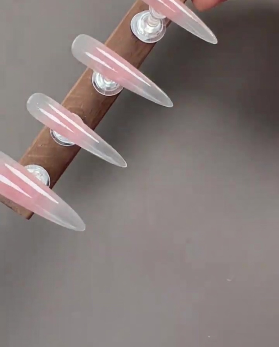Nails with cat-eye gel applied, showing the shimmering magnetic effect.