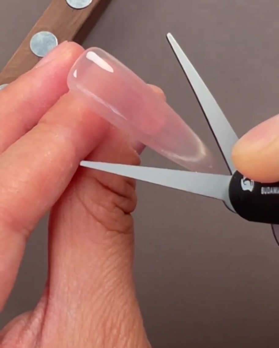 Close-up of nails with a translucent glass cat-eye gel finish.