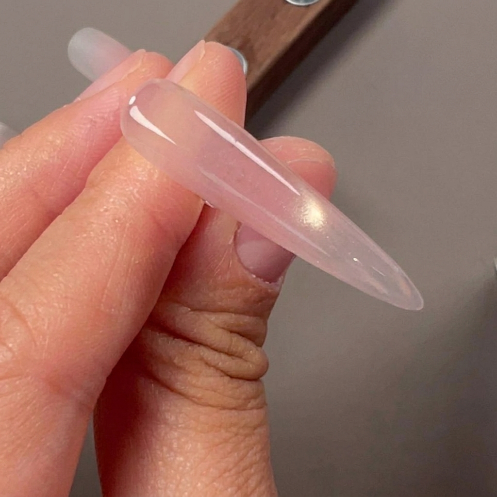 A nail featuring a sharp cat-eye side light effect created with a magnet.