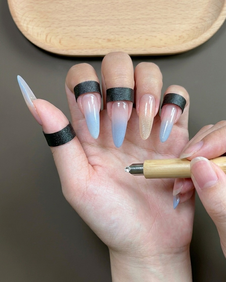 A cylindrical magnet hovering over the index finger to pull the magnetic pigments into a bright, reflective streak.