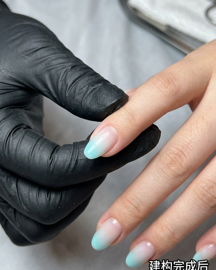 A makeup sponge dabbing blue and beige gel polish onto a nail to create an ombre effect.