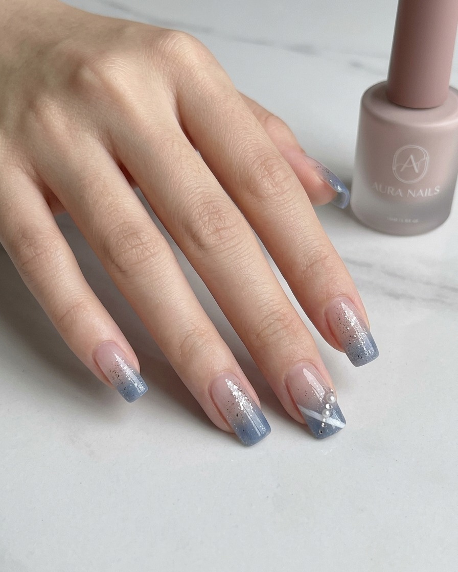 Tweezers placing a small, sparkling rhinestone onto a decorated nail.