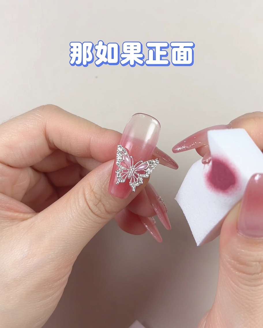 A clean section of a cosmetic sponge being used to gently smooth out a concentrated area of gel polish on a nail.
